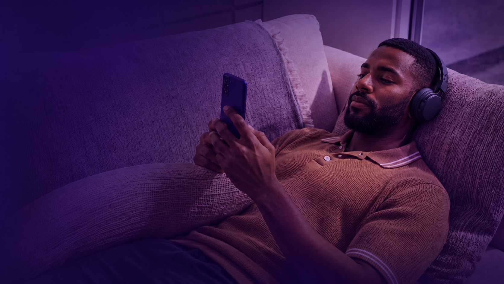 Person relaxing while managing investments on their phone